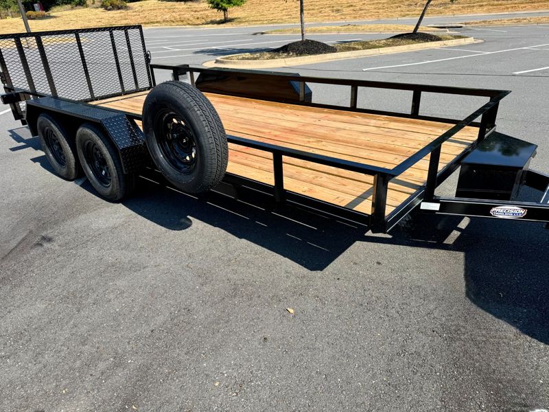 Side view of the 16-foot utility trailer showing tandem axles and wood deck